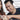 Asian woman showing a man next to her something on her phone. That man's speech bubble demonstrates an example of negging commentary: "Wow, that’s a great photo of you, I didn’t think you could be that photogenic!"