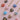 handpainted wooden heart-shaped pendants with gold plated brass chains. The pendants are painted with various designs in blue, pink, green, red, and white. Each pendant has a pearl or gold bead on the pendant.