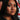 A hispanic native american multi cultural woman confidently holding up a finger to indicate "no" standing in front of a pedestrian "no walk" sign